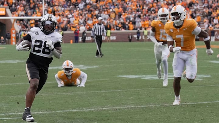 Vanderbilt running back Sedrick Alexander (28) runs the ball into the the end zone for touchdown past Tennessee linebacker Arion Carter (7) during the first quarter at Neyland Stadium in Knoxville, Tenn., Saturday, Nov. 29, 2025.