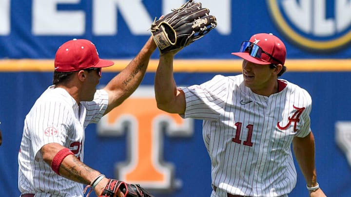 May 21 2024; Hoover, AL, USA; Alabama outfielder Ian Petrutz (21) celebrates with Alabama outfielder William Hamiter (11) after Hamiter made a diving catch to end the first inning at the Hoover Met on the opening day of the SEC Tournament.