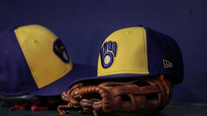Jul 28, 2023; Atlanta, Georgia, USA; A detailed view of a Milwaukee Brewers hat and glove on the bench against the Atlanta Braves in the second inning at Truist Park. Mandatory Credit: Brett Davis-Imagn Images