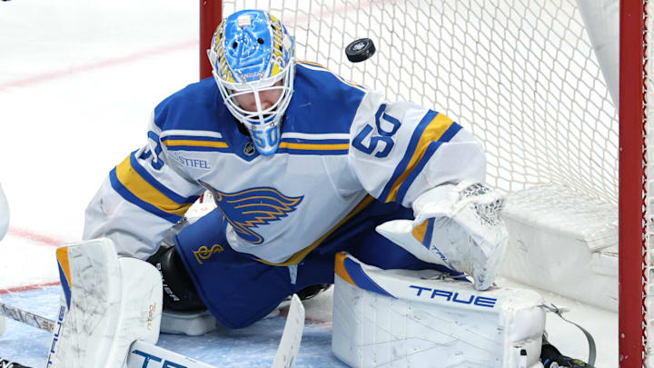 Mar 15, 2026; Winnipeg, Manitoba, CAN; A puck flies over St. Louis Blues goaltender Jordan Binnington (50) during a game against the Winnipeg Jets in the second period at Canada Life Centre. Mandatory Credit: James Carey Lauder-Imagn Images