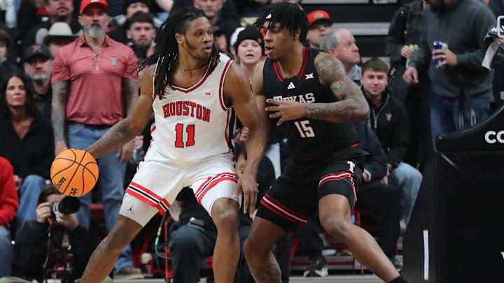 Jan 24, 2026; Lubbock, Texas, USA; Houston Cougars forward Joseph Tugler (11) works the ball against Texas Tech Red Raiders forward JT Toppin (15) in the first half at United Supermarkets Arena. Mandatory Credit: Michael C. Johnson-Imagn Images Jan 24, 2026; Lubbock, Texas, USA; Houston Cougars forward Joseph Tugler (11) works the ball against Texas Tech Red Raiders forward JT Toppin (15) in the first half at United Supermarkets Arena. Mandatory Credit: Michael C. Johnson-Imagn Images