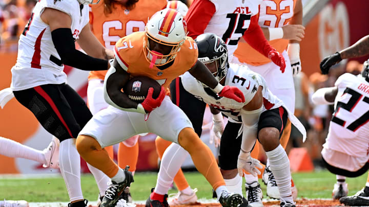 Oct 27, 2024; Tampa, Florida, USA; Tampa Bay Buccaneers running back Bucky Irving (7) runs the ball  in the first quarter against the Atlanta Falcons at Raymond James Stadium. Mandatory Credit: Jonathan Dyer-Imagn Images