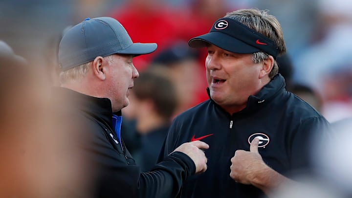 Georgia coach Kirby Smart speaks with Kentucky coach Mark Stoops before the start of a NCAA college football game against Kentucky in Athens, Ga., on Saturday, Oct. 7, 2023.