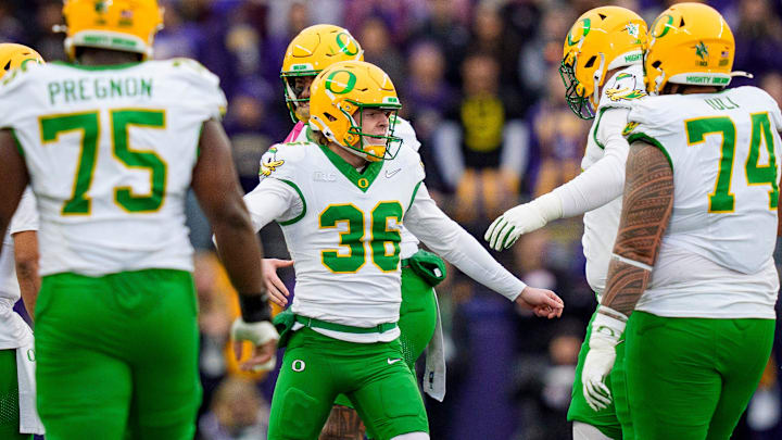 Oregon kicker Atticus "Automatic" Sappington celebrates a field goal with the field goal team. He hit four as the Ducks dropped Washington in Husky Stadium, 26-14.