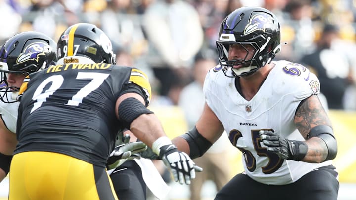Nov 17, 2024; Pittsburgh, Pennsylvania, USA;  Baltimore Ravens guard Patrick Mekari (65) blocks at the line of scrimmage against Pittsburgh Steelers defensive tackle Cameron Heyward (97) during the first quarter at Acrisure Stadium. Mandatory Credit: Charles LeClaire-Imagn Images