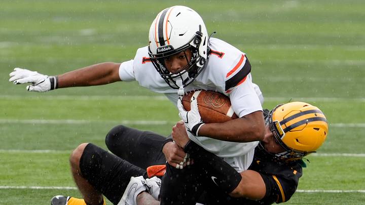 Dearborn (1) Walter Adams gets tackled after the catch by Dearborn Fordson (7) Laith Aljanaby during first half action at Dearborn Fordson High School in Dearborn on Saturday, Sept. 19, 2026. Dearborn (1) Walter Adams gets tackled after the catch by Dearborn Fordson (7) Laith Aljanaby during first half action at Dearborn Fordson High School in Dearborn on Saturday, Sept. 19, 2026.