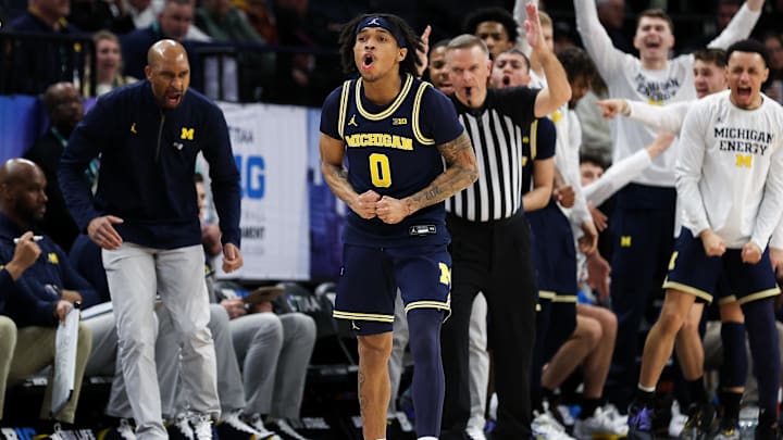 Mar 13, 2024; Minneapolis, MN, USA; Michigan Wolverines guard Dug McDaniel (0) celebrates his three-point shot against Penn State in the Big Ten Tournament.