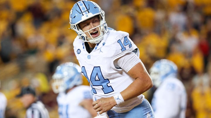 Aug 29, 2024; Minneapolis, Minnesota, USA; North Carolina Tar Heels quarterback Max Johnson (14) celebrates his rushing touchdown against the Minnesota Golden Gophers.