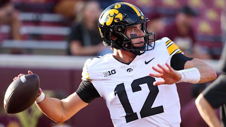 Sep 21, 2024; Minneapolis, Minnesota, USA; Iowa Hawkeyes quarterback Cade McNamara (12) warms up before the game against the Minnesota Golden Gophers at Huntington Bank Stadium.