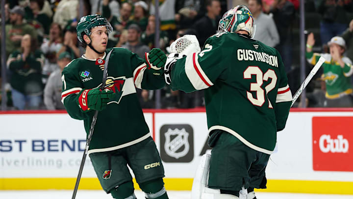 Oct 10, 2024; Saint Paul, Minnesota, USA; Minnesota Wild goaltender Filip Gustavsson (32) and defenseman Brock Faber (7) celebrate their teams win against the Columbus Blue Jackets after the game at Xcel Energy Center. Mandatory Credit: Matt Krohn-Imagn Images