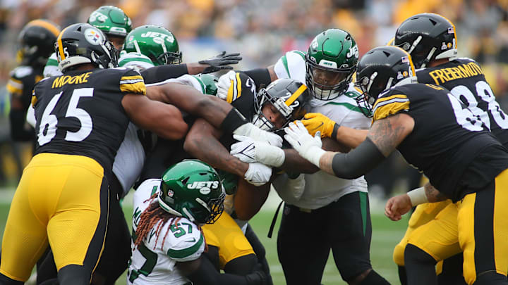 Najee Harris (22) of the Pittsburgh Steelers pushes his way through the New York Jets defensive line during the first half at Acrisure Stadium in Pittsburgh, PA on October 2, 2022.
