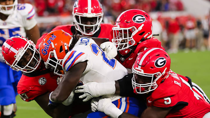 Georgia Bulldogs defensive lineman Mykel Williams (left) wraps up Florida Gators running back Ja'Kobi Jackson. Georgia Bulldogs defensive lineman Mykel Williams (left) wraps up Florida Gators running back Ja'Kobi Jackson.