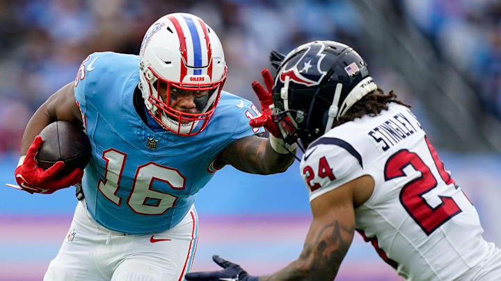 Tennessee Titans wide receiver Treylon Burks (16) stiff arms Houston Texans cornerback Derek