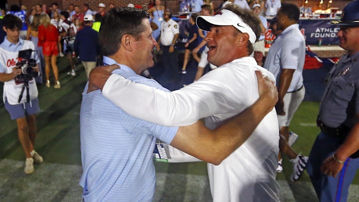 Sep 13, 2025; Oxford, Mississippi, USA; Mississippi Rebels head coach Lane Kiffin (right) reacts with Vice Chancellor for Intercollegiate Athletics Keith Carter (left) after defeating the Arkansas Razorback at Vaught-Hemingway Stadium. Mandatory Credit: Petre Thomas-Imagn Images