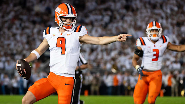 Illinois quarterback Luke Altmyer (9) points to one of his blockers as he runs with the ball in the second quarter of a Big Ten football game against Penn State, Saturday, Sept. 28, 2024, in State College, Pa.