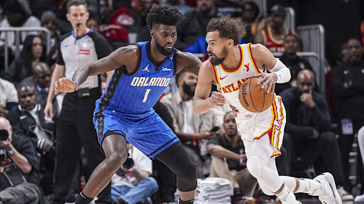 Atlanta Hawks guard Trae Young (11) dribbles against Orlando Magic forward Jonathan Isaac (1) during the first half at State Farm Arena.