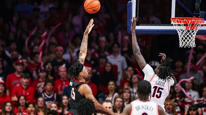 Feb 14, 2026; Tucson, Arizona, USA; Texas Tech Red Raiders forward JT Toppin (15) makes a layup over Arizona Wildcats forward Sidi Gueye (15) during the second half of the game at McKale Memorial Center. Mandatory Credit: Aryanna Frank-Imagn Images