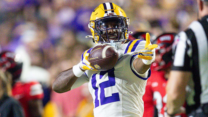 Nov 22, 2025; Baton Rouge, Louisiana, USA;  LSU Tigers wide receiver Kyle Parker (12) reacts to making a first down against Western Kentucky Hilltoppers defensive back Nazir Ward (not pictured) during the first half at Tiger Stadium. Mandatory Credit: Stephen Lew-Imagn Images