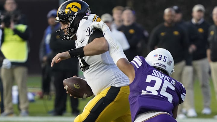 Nov 4, 2023; Chicago, Illinois, USA; Northwestern Wildcats linebacker Kenny Soares Jr. (35) pressures Iowa Hawkeyes quarterback Deacon Hill (10) during the second half at Wrigley Field. Mandatory Credit: David Banks-Imagn Images