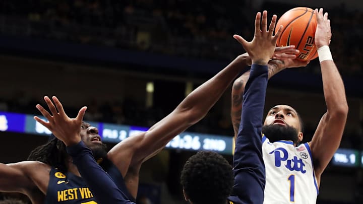 Nov 15, 2024; Pittsburgh, Pennsylvania, USA;  Pittsburgh Panthers guard Damian Dunn (1) shoots against West Virginia Mountaineers center Eduardo Andre (0) and guard KJ Tenner (3) during the second half at the Petersen Events Center. Mandatory Credit: Charles LeClaire-Imagn Images