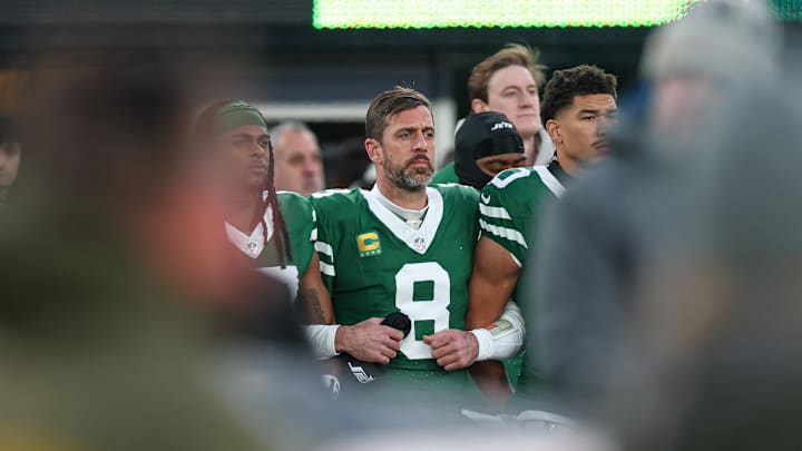 Jan 5, 2025; East Rutherford, New Jersey, USA; New York Jets quarterback Aaron Rodgers (8) stands with teammates during the national anthem before the game against the Miami Dolphins at MetLife Stadium. Mandatory Credit: Vincent Carchietta-Imagn Images