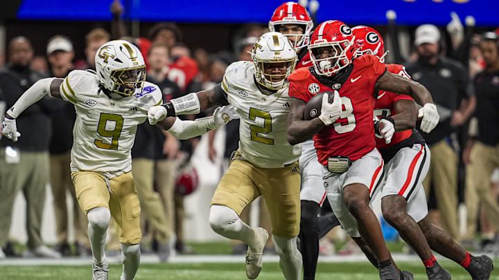 Nov 28, 2025; Atlanta, Georgia, USA; Georgia Bulldogs running back Nate Frazier (3) runs against Georgia Tech Yellow Jackets linebacker E.J. Lightsey (2) during the first half at Mercedes-Benz Stadium. Mandatory Credit: Dale Zanine-Imagn Images