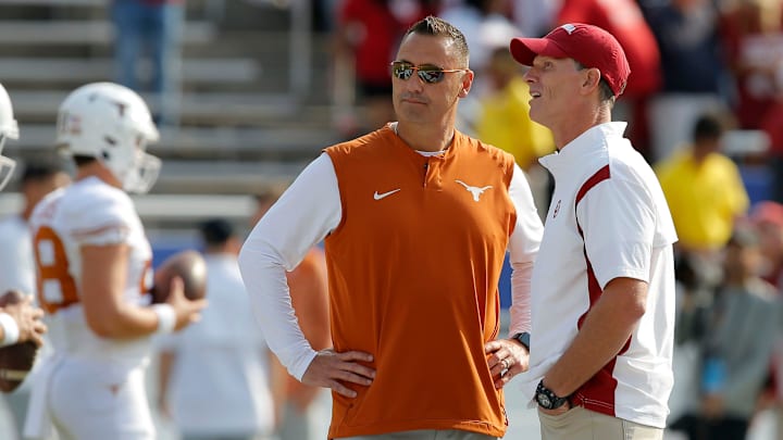 Oklahoma Sooners head coach Brent Venables and Texas Longhorns head coach Steve Sarkisian talk before the Red River Showdown. Oklahoma Sooners head coach Brent Venables and Texas Longhorns head coach Steve Sarkisian talk before the Red River Showdown.