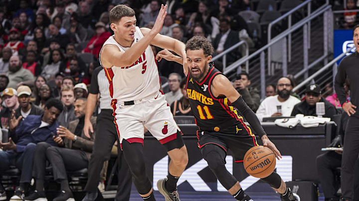 Dec 28, 2024; Atlanta, Georgia, USA; Atlanta Hawks guard Trae Young (11) dribbles against  Miami Heat forward Nikola Jovic (5) at State Farm Arena. Mandatory Credit: Dale Zanine-Imagn Images