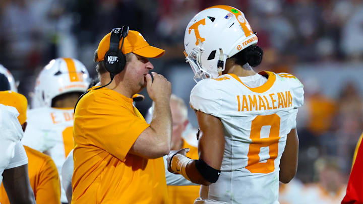 Sep 21, 2024; Norman, Oklahoma, USA; Tennessee Volunteers head coach Josh Heupel (left) speaks with Tennessee Volunteers quarterback Nico Iamaleava (8) during the first half against the Oklahoma Sooners at Gaylord Family-Oklahoma Memorial Stadium. Mandatory Credit: Kevin Jairaj-Imagn Images