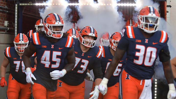 Aug 29, 2025; Champaign, Illinois, USA;  Illinois Fighting Illini players take the field before the start of an NCAA game with the Western Illinois Leathernecks at Memorial Stadium. Mandatory Credit: Ron Johnson-Imagn Images