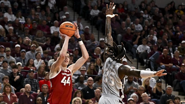 Feb 15, 2025; College Station, Texas, USA; Arkansas Razorbacks forward Zvonimir Ivisic (44) shoots a three point basket as Texas A&M Aggies guard Manny Obaseki (35) defends during the second half at Reed Arena. Mandatory Credit: Maria Lysaker-Imagn Images 