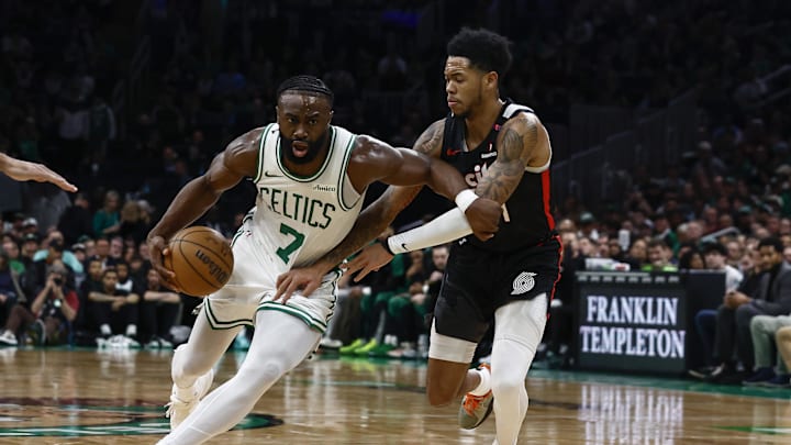 Mar 5, 2025; Boston, Massachusetts, USA; Boston Celtics guard Jaylen Brown (7) drives on Portland Trail Blazers guard Anfernee Simons (1) during the first quarter at TD Garden. Mandatory Credit: Winslow Townson-Imagn Images