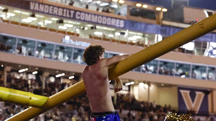 Oct 5, 2024; Nashville, Tennessee, USA; Vanderbilt Commodores fans take down the goal post after an upset victory over the Alabama Crimson Tide at FirstBank Stadium. Mandatory Credit: Butch Dill-Imagn Images Oct 5, 2024; Nashville, Tennessee, USA; Vanderbilt Commodores fans take down the goal post after an upset victory over the Alabama Crimson Tide at FirstBank Stadium. Mandatory Credit: Butch Dill-Imagn Images