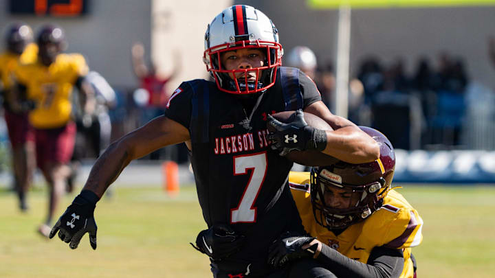 Jackson State's wide receiver Jameel Gardner, Jr., (7) runs the ball as Bethune Cookman's cornerback Devin Gunter (1) pursues him during the game at Mississippi Veterans Memorial Stadium in Jackson, Miss., on Saturday, Nov. 15, 2025.