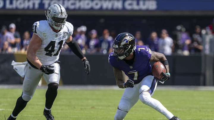 Sep 15, 2024; Baltimore, Maryland, USA;  Baltimore Ravens wide receiver Rashod Bateman (7) runs after the catch as Las Vegas Raiders linebacker Robert Spillane (41) defends during the first quarter at M&T Bank Stadium. Mandatory Credit: Tommy Gilligan-Imagn Images
