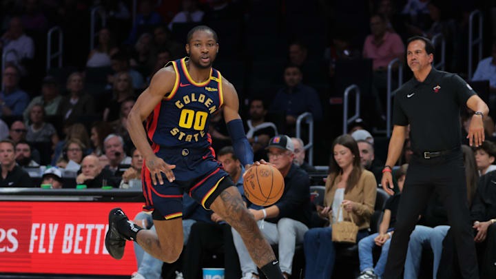 Mar 25, 2025; Miami, Florida, USA; Golden State Warriors forward Jonathan Kuminga (00) drives to the basket against the Miami Heat during the second quarter at Kaseya Center. Mandatory Credit: Sam Navarro-Imagn Images