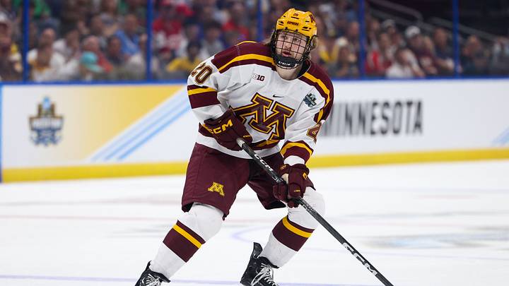 Apr 6, 2023; Tampa, Florida, USA; Minnesota defenseman Luke Mittelstadt (20)controls the puck against Boston University in the first period in the semifinals of the 2023 Frozen Four college ice hockey tournament at Amalie Arena. Mandatory Credit: Nathan Ray Seebeck-USA TODAY Sports