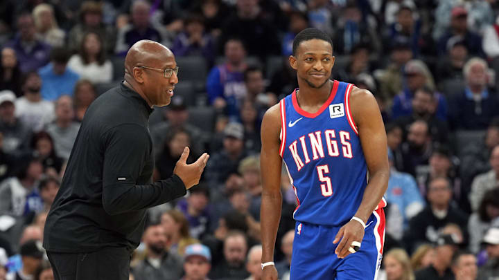Nov 16, 2024; Sacramento, California, USA; Sacramento Kings head coach Mike Brown (left) talks with guard De'Aaron Fox (5) during the second quarter against the Utah Jazz at Golden 1 Center. Mandatory Credit: Darren Yamashita-Imagn Images
