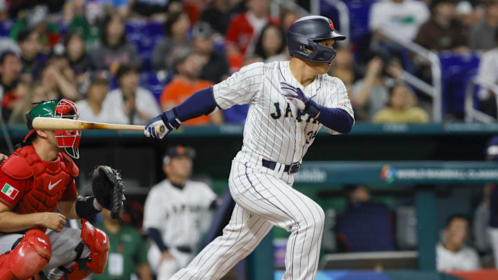 Mar 20, 2023; Miami, Florida, USA; Japan left fielder Masataka Yoshida (34) hits a single during the second inning against Mexico at LoanDepot Park. Mandatory Credit: Sam Navarro-Imagn Images Mar 20, 2023; Miami, Florida, USA; Japan left fielder Masataka Yoshida (34) hits a single during the second inning against Mexico at LoanDepot Park. Mandatory Credit: Sam Navarro-Imagn Images