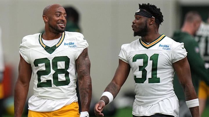 Green Bay Packers running back AJ Dillon talks with running back Emanuel Wilson