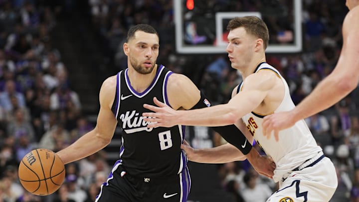 Apr 9, 2025; Sacramento, California, USA; Sacramento Kings guard Zach LaVine (8) controls the ball against Denver Nuggets guard Christian Braun (0) during the third quarter at Golden 1 Center. Mandatory Credit: Ed Szczepanski-Imagn Images