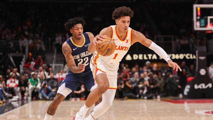 Dec 2, 2024; Atlanta, Georgia, USA; Atlanta Hawks forward Jalen Johnson (1) drives past New Orleans Pelicans guard Elfrid Payton (22) in the second quarter at State Farm Arena. Mandatory Credit: Brett Davis-Imagn Images