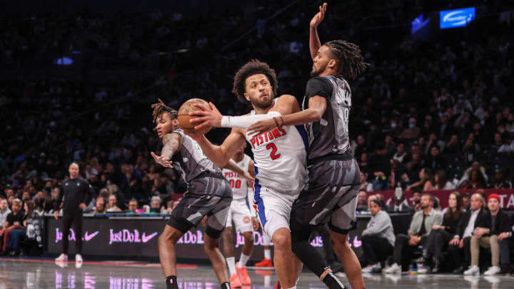 Jan 8, 2025; Brooklyn, New York, USA;  Detroit Pistons guard Cade Cunningham (2) looks to drive past Brooklyn Nets forward Ziaire Williams (8) in the second quarter at Barclays Center. Mandatory Credit: Wendell Cruz-Imagn Images
