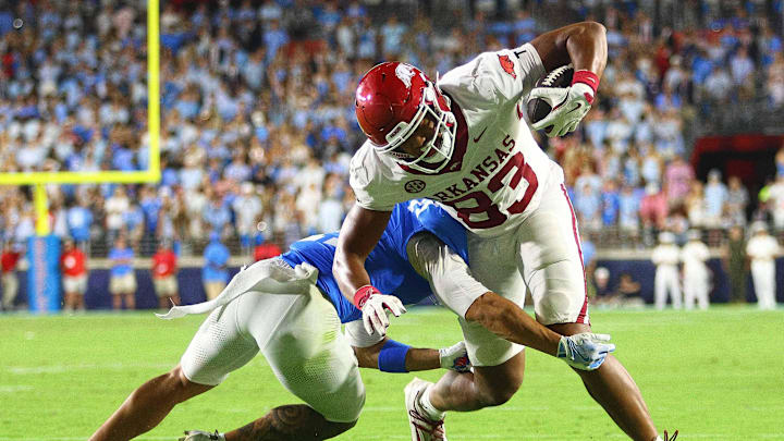 Sep 13, 2025; Oxford, Mississippi, USA; Arkansas Razorback tight end Jaden Platt (83) runs after a catch as Mississippi Rebels defensive back Kapena Gushiken (14) make the tackle during the fourth quarter at Vaught-Hemingway Stadium. Mandatory Credit: Petre Thomas-Imagn Images