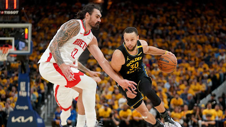 May 2, 2025; San Francisco, California, USA; Golden State Warriors guard Stephen Curry (30) dribbles past Houston Rockets center Steven Adams (12) in the third quarter of game six of the first round for the 2025 NBA Playoffs at Chase Center. Mandatory Credit: Cary Edmondson-Imagn Images