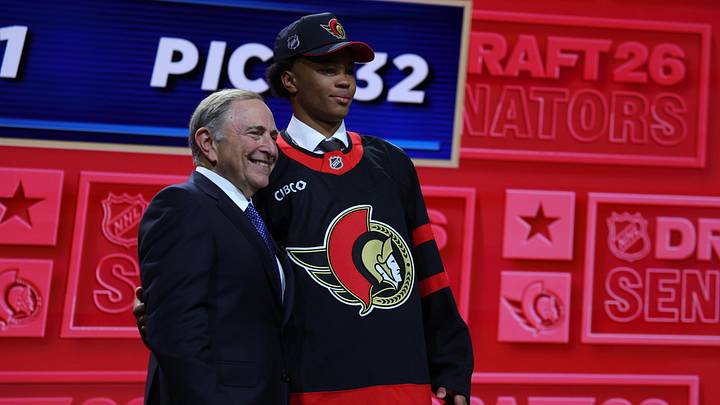 Jun 26, 2026; Buffalo, New York, USA; Jaxson Cover reacts beside NHL commissioner Gary Bettman after being selected with the thirty second pick in the first round of the 2026 NHL Draft by the Ottawa Senators at KeyBank Center. Mandatory Credit: Timothy T. Ludwig-Imagn Images