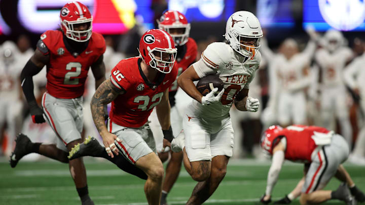 Dec 7, 2024; Atlanta, GA, USA; Texas Longhorns wide receiver DeAndre Moore Jr. (0) makes a touchdown catch against the Georgia Bulldogs during the second half in the 2024 SEC Championship game at Mercedes-Benz Stadium. Mandatory Credit: Brett Davis-Imagn Images