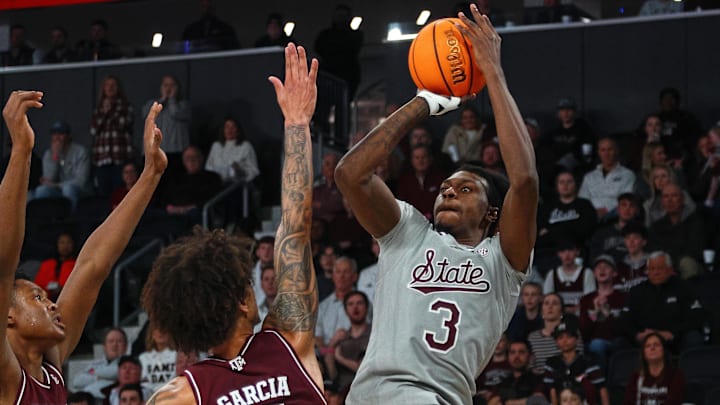Feb 18, 2025; Starkville, Mississippi, USA; Mississippi State Bulldogs forward KeShawn Murphy (3) shoots against Texas A&M Aggies forward/center Pharrel Payne (21) and forward Andersson Garcia (11) during the second half at Humphrey Coliseum. Mandatory Credit: Petre Thomas-Imagn Images