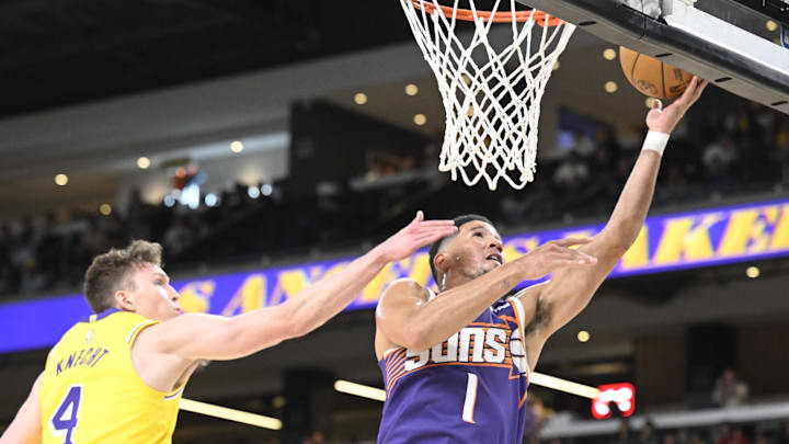 Oct 3, 2025; Palm Desert, California, USA; Phoenix Suns guard Devin Booker (1) shoots past Los Angeles Lakers guard Dalton Knecht (4) at Acrisure Arena. Mandatory Credit: Denis Poroy-Imagn Images