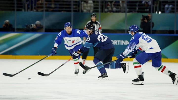 Feb 14, 2026; Milan, Italy; Sebastian Aho of Finland in action with Luca Frigo of Italy and Daniel Glira of Italy in men's ice hockey group B play during the Milano Cortina 2026 Olympic Winter Games at Milano Santagiulia Ice Hockey Arena. Mandatory Credit: Geoff Burke-Imagn Images